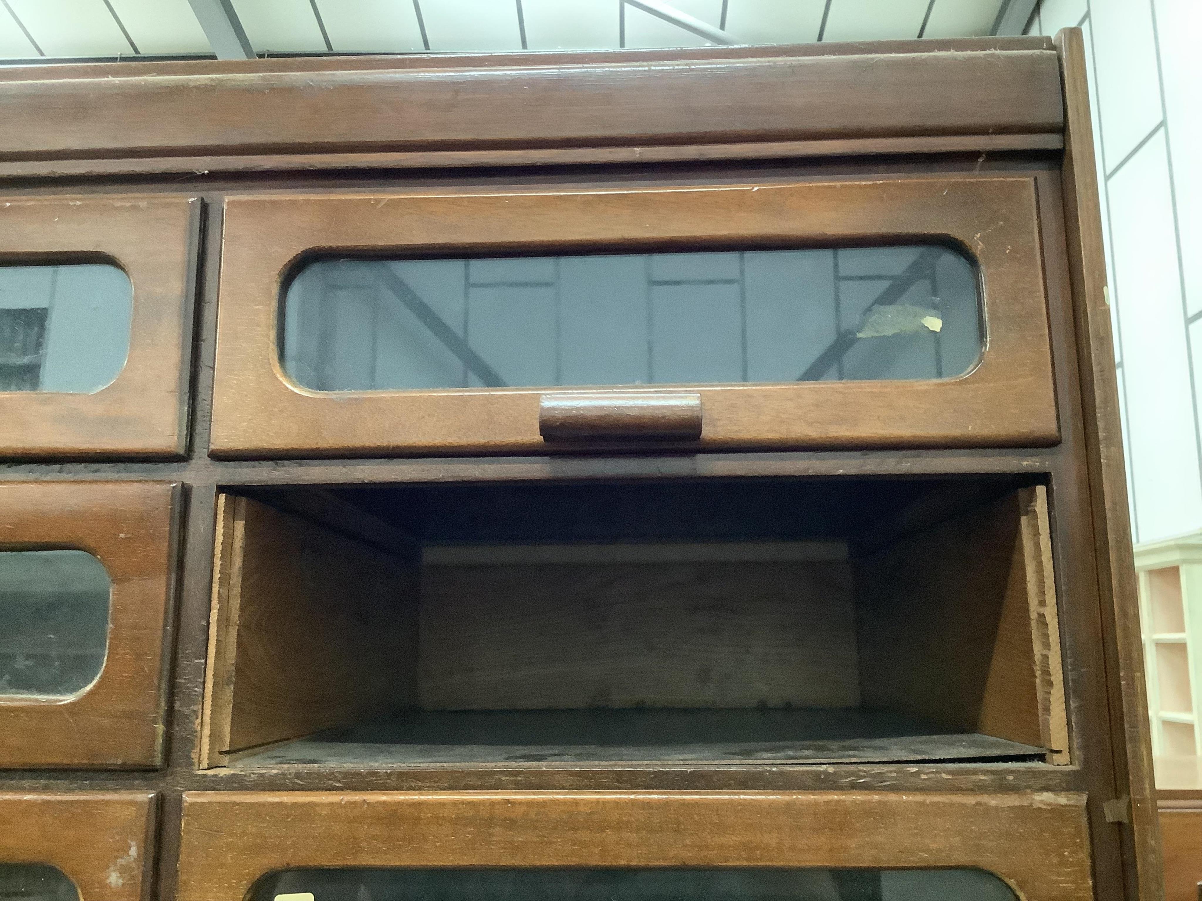 A large mid century mahogany haberdasher's cabinet, width 183cm, depth 50cm, height 199cm. Condition - poor